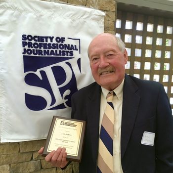 Leo Jeffres holding an award